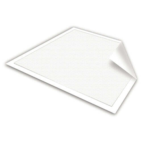 Disposable underpad with white textured absorbent surface and peeled corner showing backing layer, lying flat at an angle