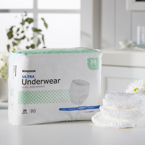 McKesson Ultra absorbent underwear package in medium size with 20 count, displayed beside folded pull-up briefs on a white