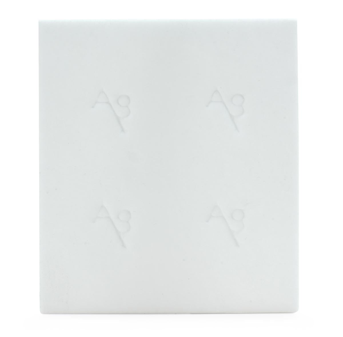 Collagen wound dressing, white square pad with embossed logo pattern, shown on white background