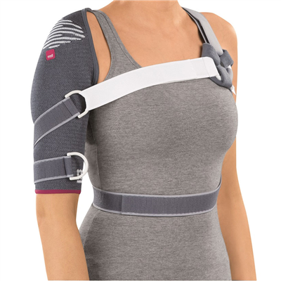Shoulder support brace in gray knit fabric with white straps worn on left shoulder and secured around torso