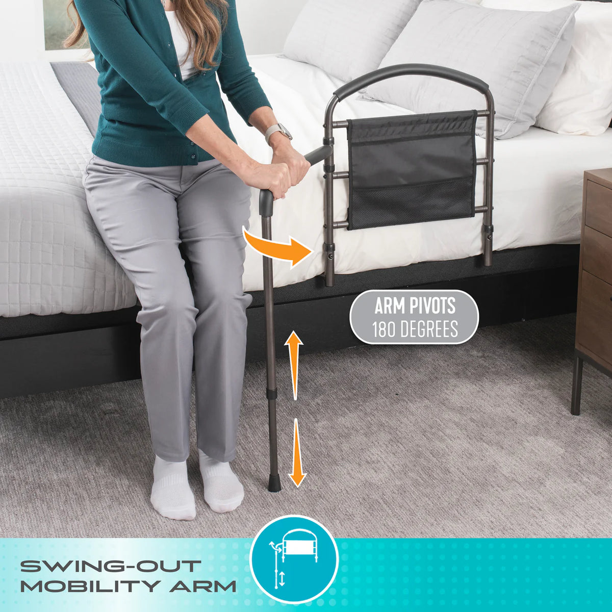 Mobility bed rail with swing-out arm shown in use as woman grips pivoting support handle while rising from bed