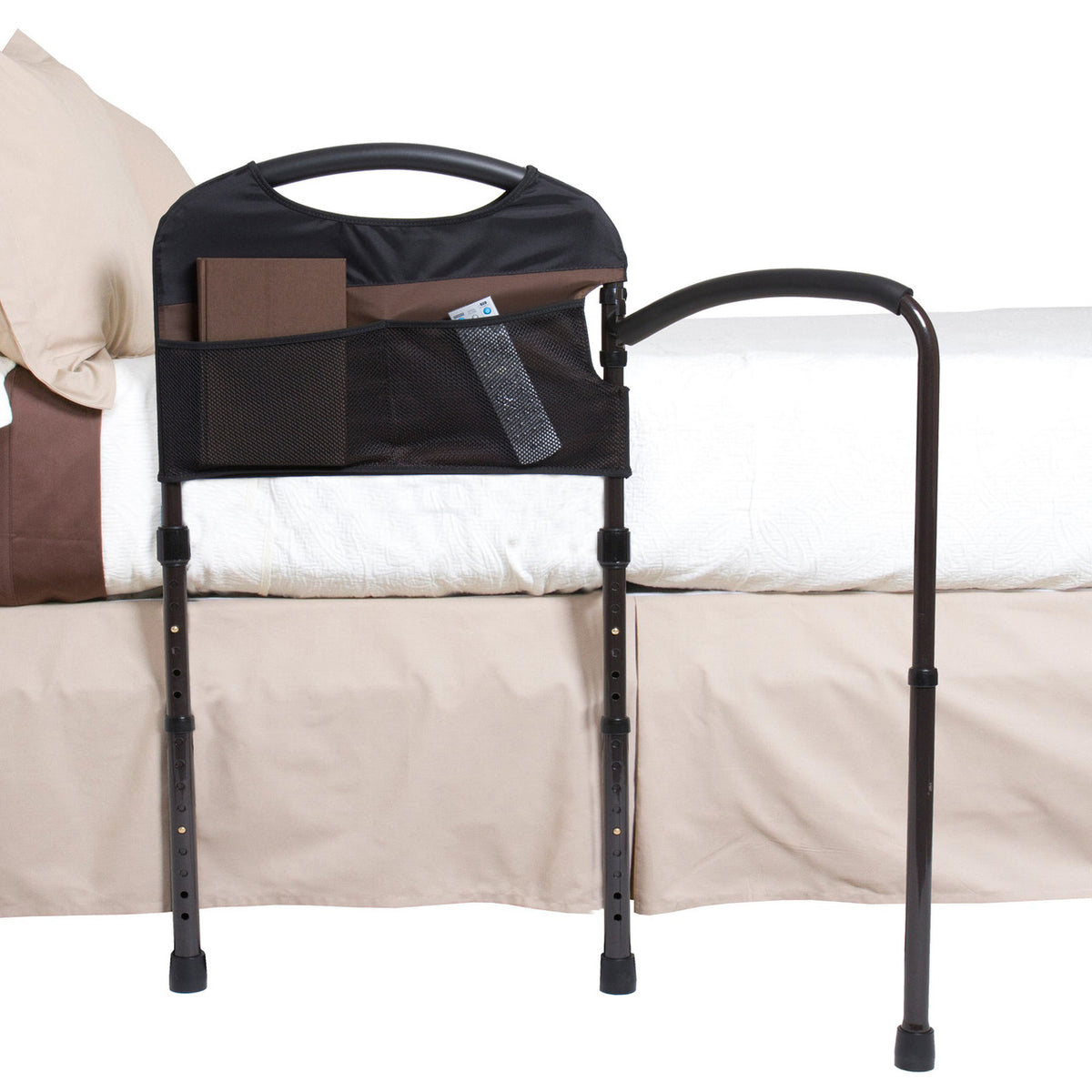 Mobility bed rail with padded grab handle, mesh storage pocket, and adjustable floor-support legs, shown mounted on a bed