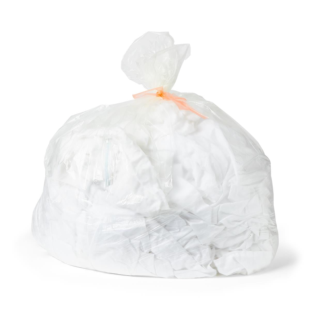 Water soluble laundry bag filled with white linens, tied closed with an orange tie, on white background