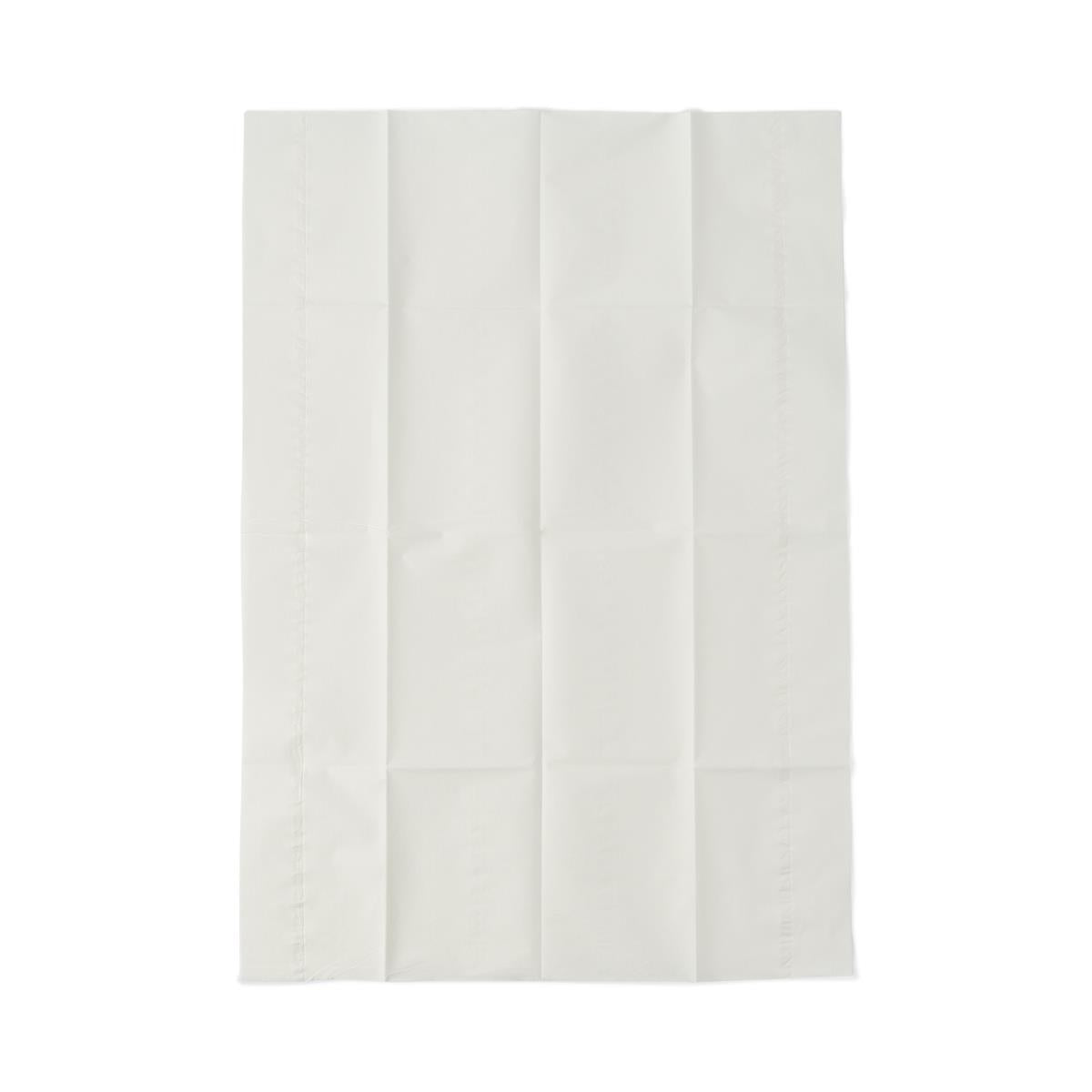 Disposable poly-lined drape in white, folded flat showing crease lines, with stitched edge visible on left side