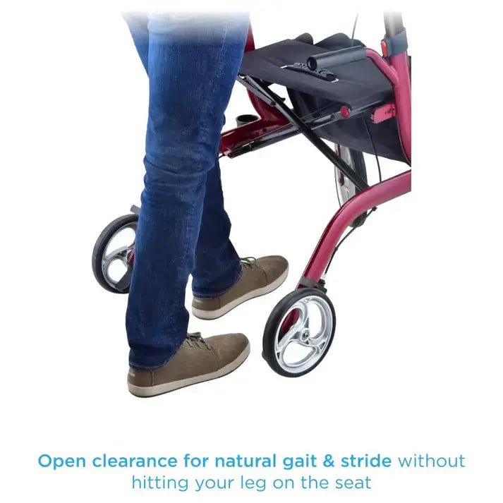 Rollator walker with red frame showing open leg clearance as user in jeans and casual shoes walks alongside it