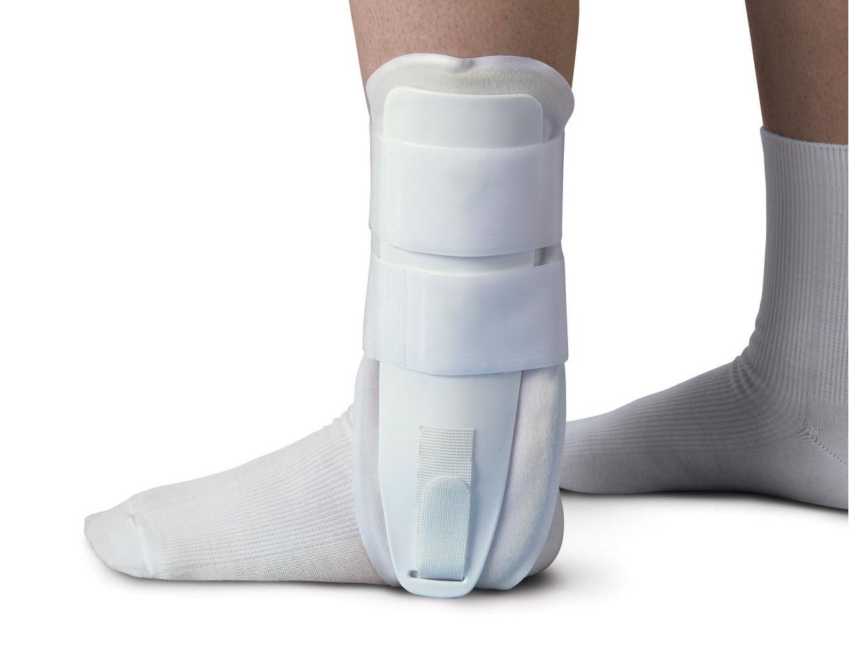 Foam stirrup-style ankle brace with hook-and-loop straps worn over a white sock on a person's ankle and foot