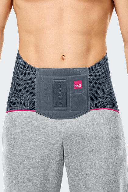 Lumbamed Basic lumbar support brace worn by male model, gray knit with pink trim and front padded panel