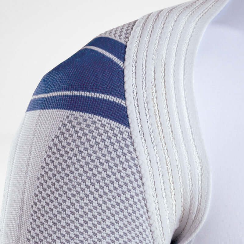 OmoTrain shoulder brace close-up showing gray knit fabric with blue stripe detail and ribbed edge stitching