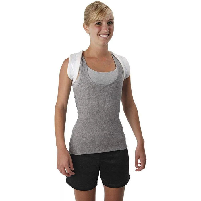 Ossur Figure 8 Clavicle brace worn by a smiling woman in a gray tank top, white straps visible over both shoulders