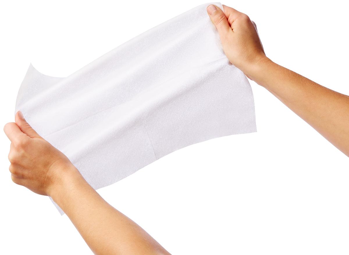 Dry cleansing wipe being stretched between two hands, showing soft white nonwoven fabric texture against white background