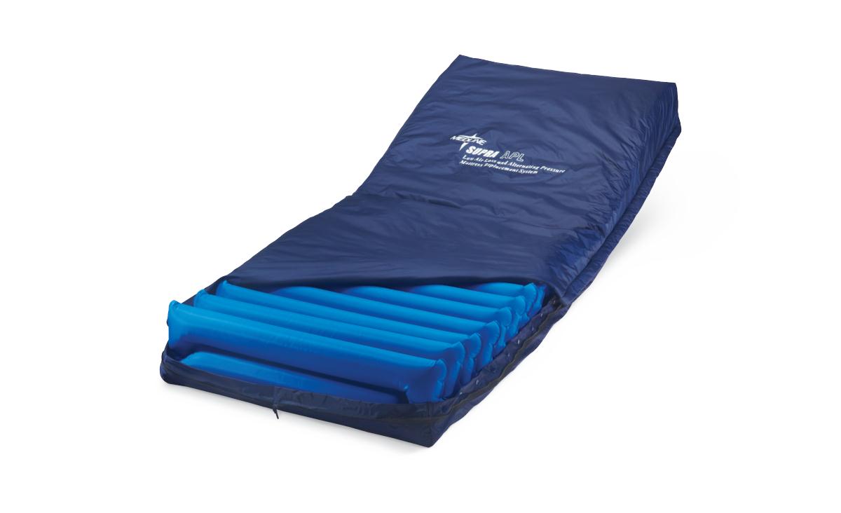 Alternating pressure mattress replacement system with navy blue cover partially open revealing blue air cells underneath