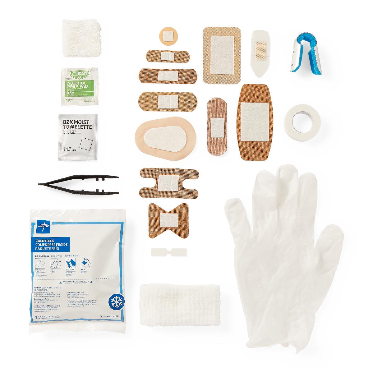 First aid kit contents laid flat including assorted bandages, gauze, gloves, cold pack, alcohol prep pads, tweezers, and