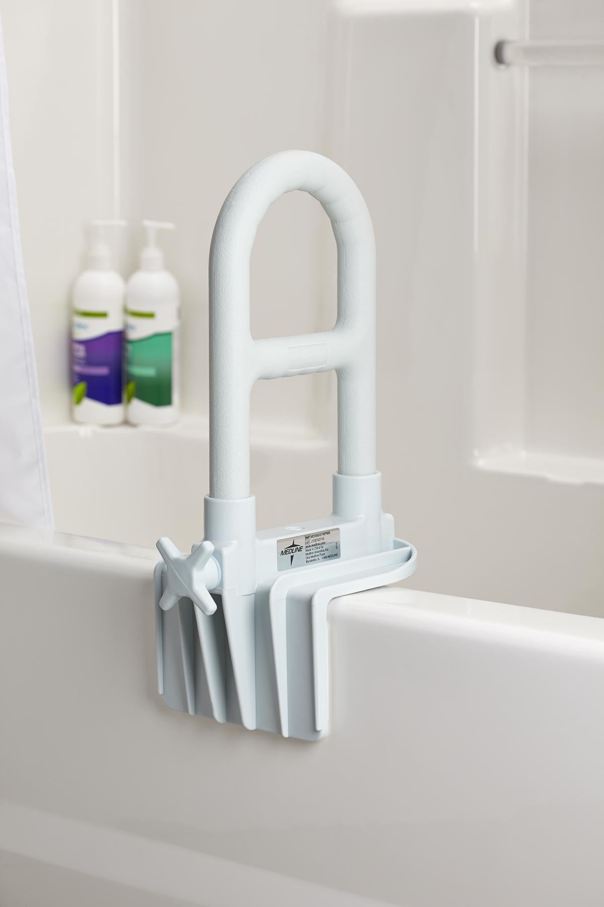 White bathtub grab bar with clamp-on base mounted on the edge of a white bathtub, shown in a bathroom setting