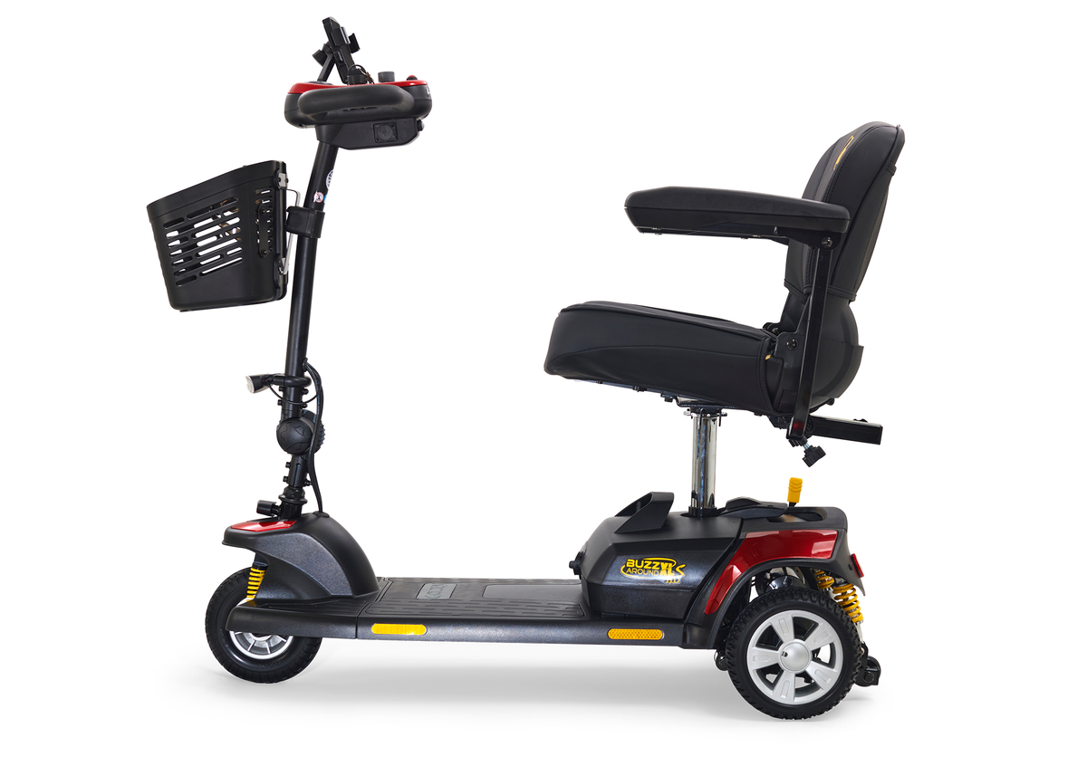 Power mobility scooter with black padded seat, front basket, tiller controls, red accents, and three wheels on white