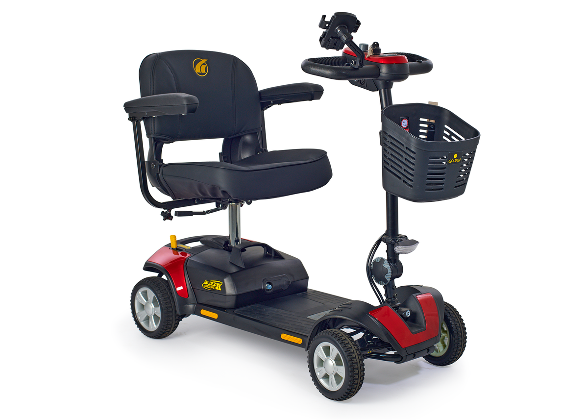 Four-wheel mobility scooter in red and black with padded seat, tiller steering, and front storage basket on white background