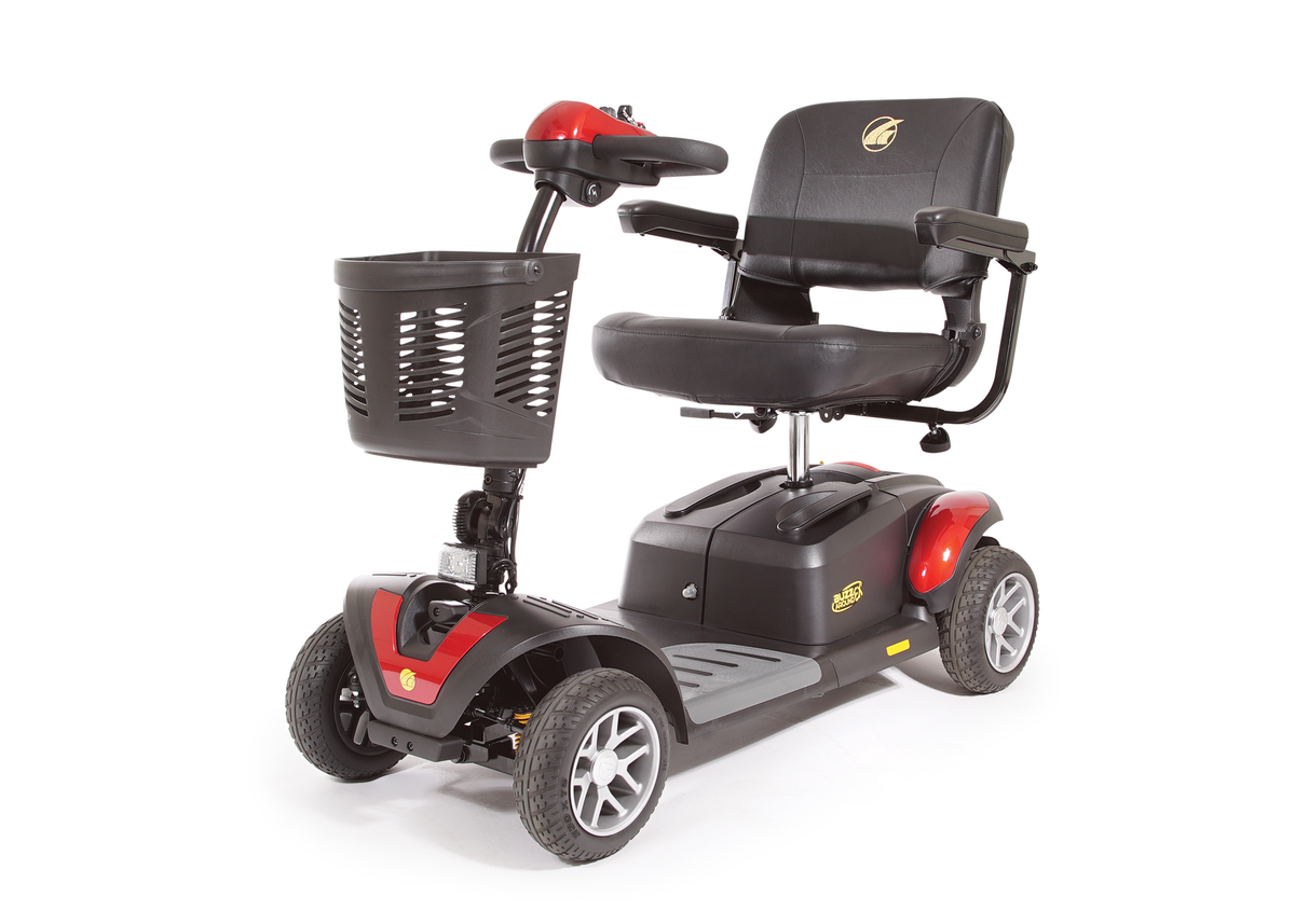 Four-wheel power mobility scooter in red and black with padded seat, armrests, tiller steering, and front storage basket