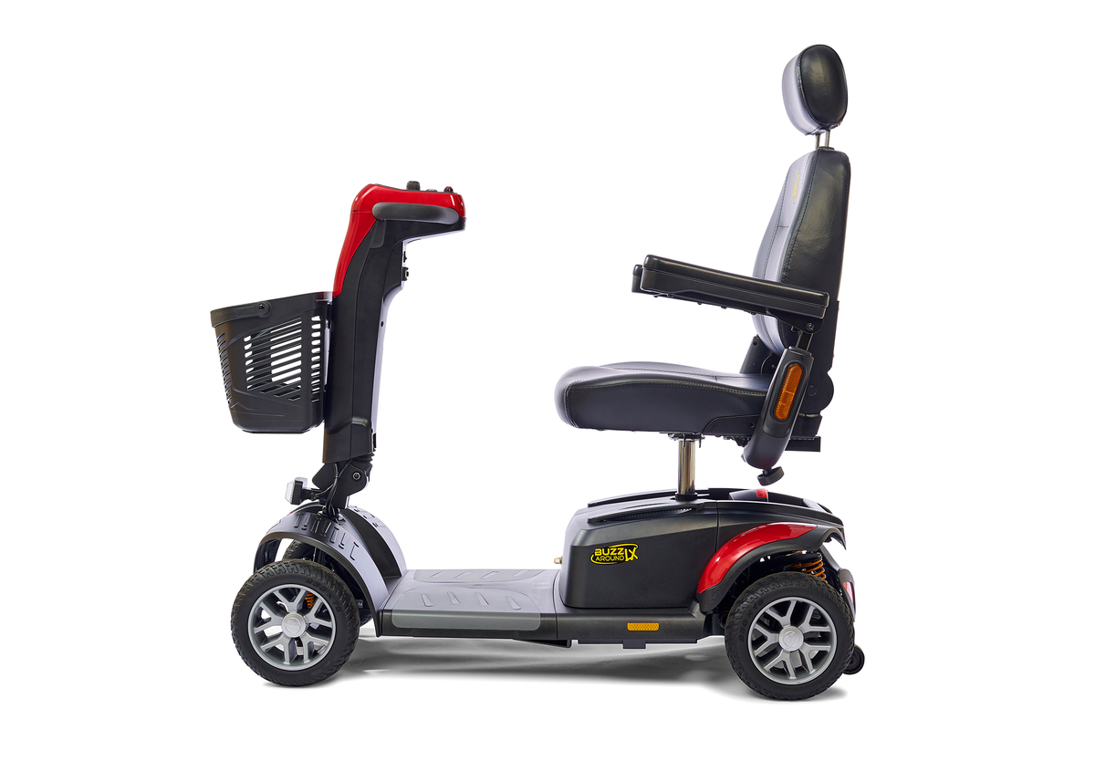 BuzzAround LX 4-wheel travel scooter in red and black, side view, with padded captain's seat, headrest, and front basket