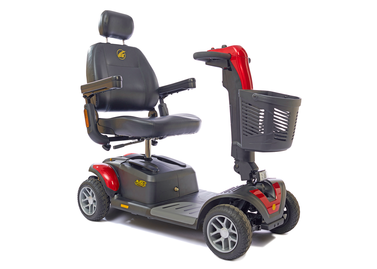 Four-wheel mobility scooter in red and gray with black captain's seat, headrest, armrests, tiller steering, and front basket