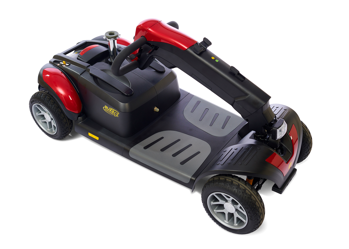 BuzzAround LX 4-wheel travel mobility scooter in red and black, shown from an elevated angle on white background