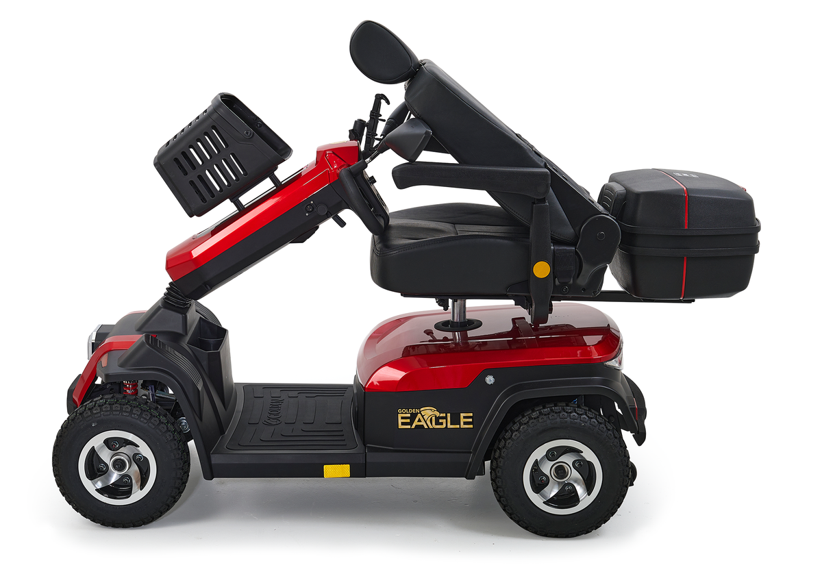 4-wheel heavy-duty mobility scooter in red and black with rear storage box, padded seat, and knobby tires, side view on