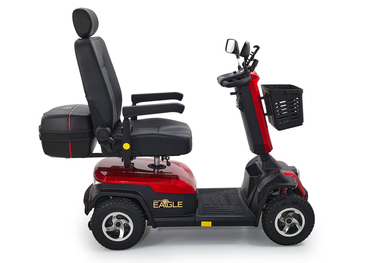 4-wheel heavy-duty mobility scooter in red with high-back seat, armrests, front basket, rear storage box, and mirror, side