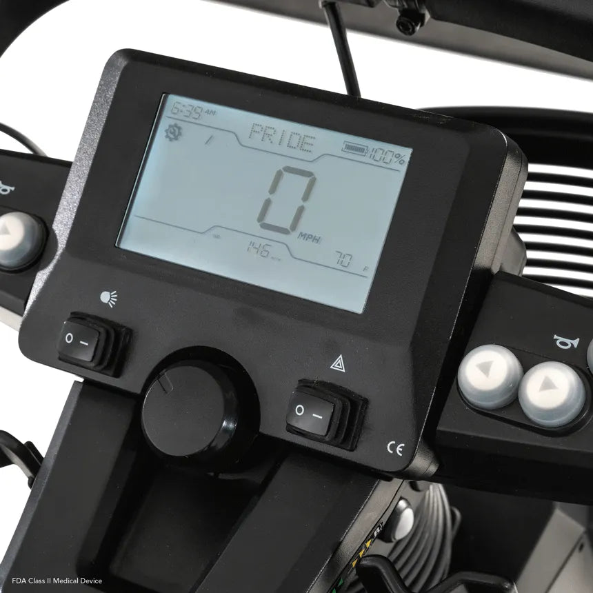Power scooter LCD control panel showing speed, battery level at 100%, and toggle switches on black tiller console