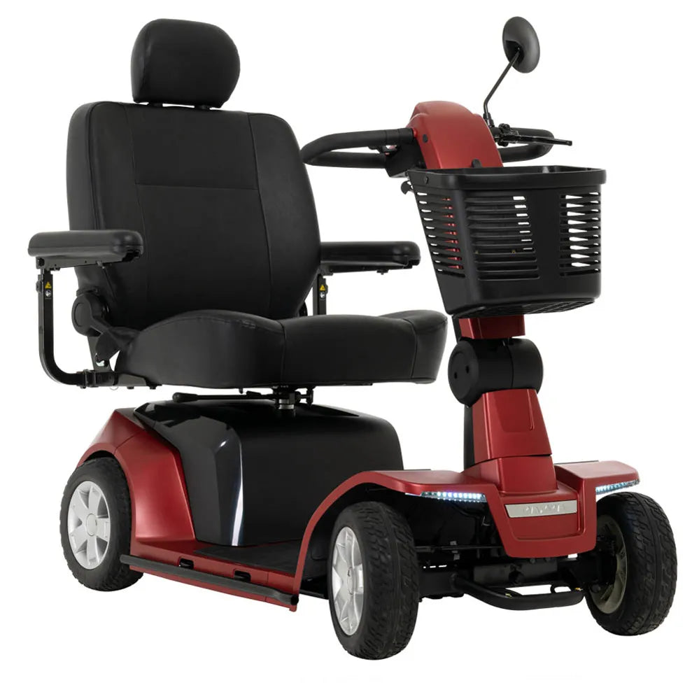 Four-wheel power mobility scooter in red with black padded captain's seat, armrests, front basket, rearview mirror, and LED
