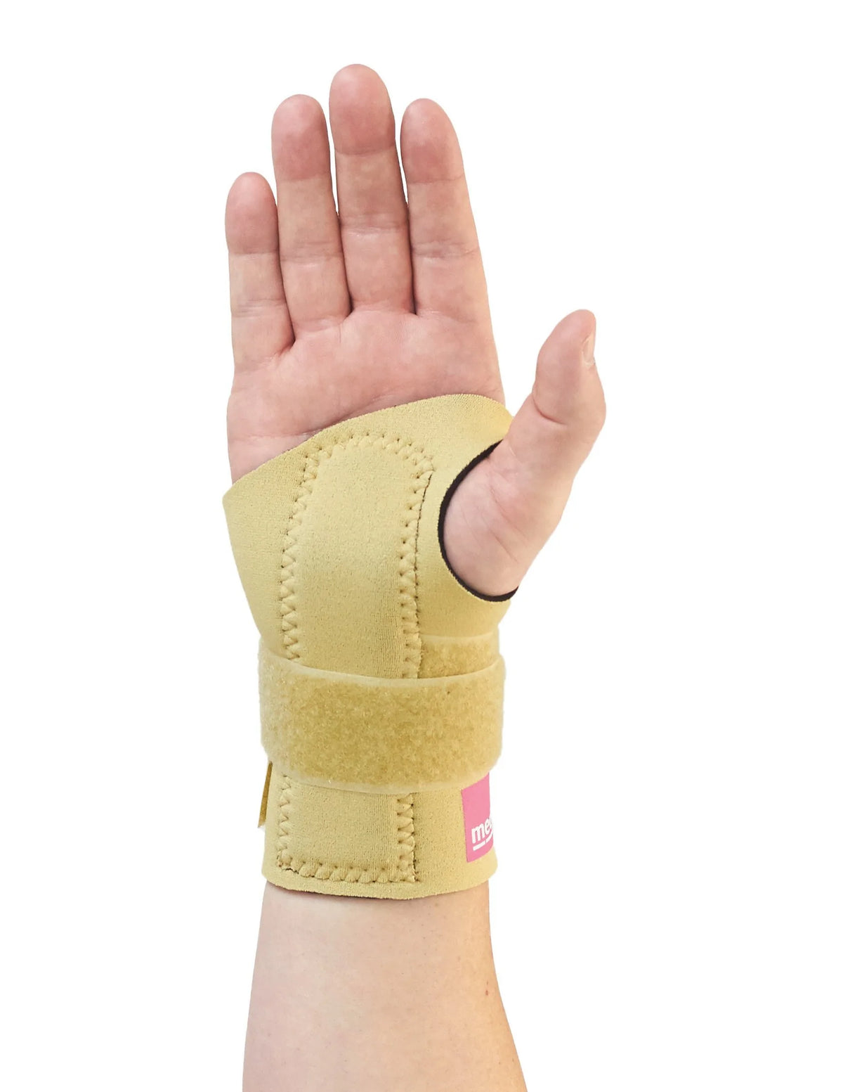 Wrist brace with thumb loop and adjustable hook-and-loop strap in beige neoprene, shown worn on a left hand, palm facing