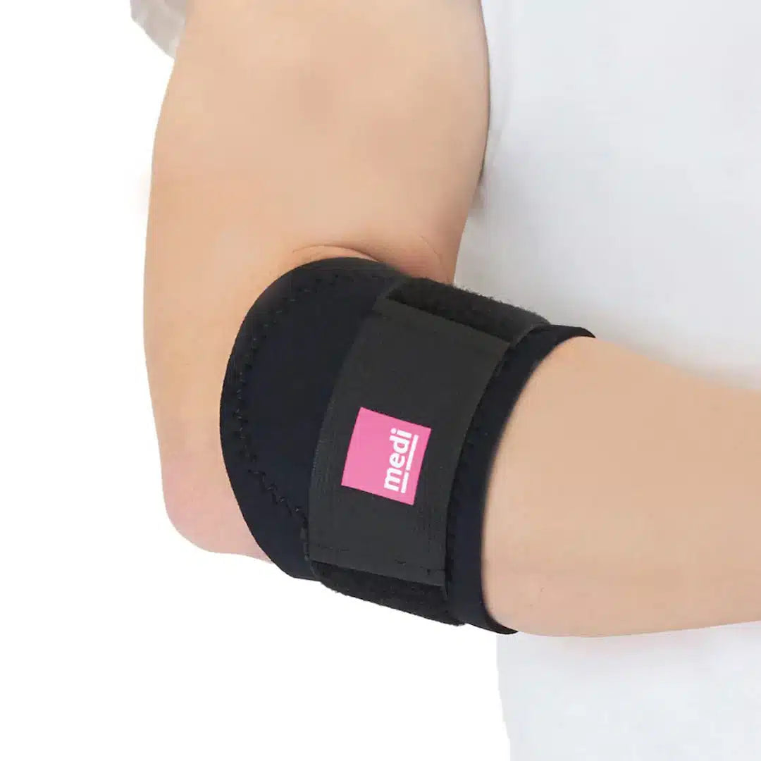Tennis elbow strap in black neoprene with pink logo label and adjustable hook-and-loop closure, worn on a bent elbow
