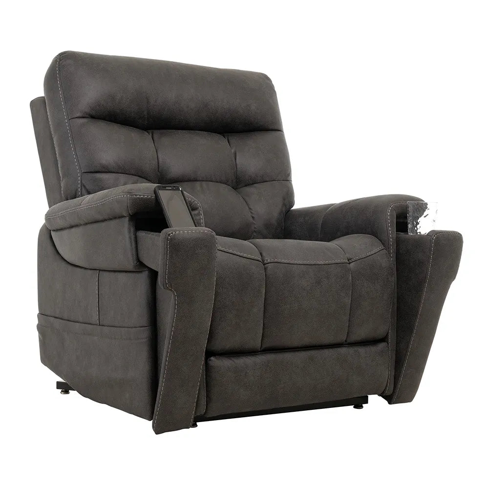 Lift chair in dark gray tufted fabric upholstery with padded armrests and a hand control tucked into the side pocket