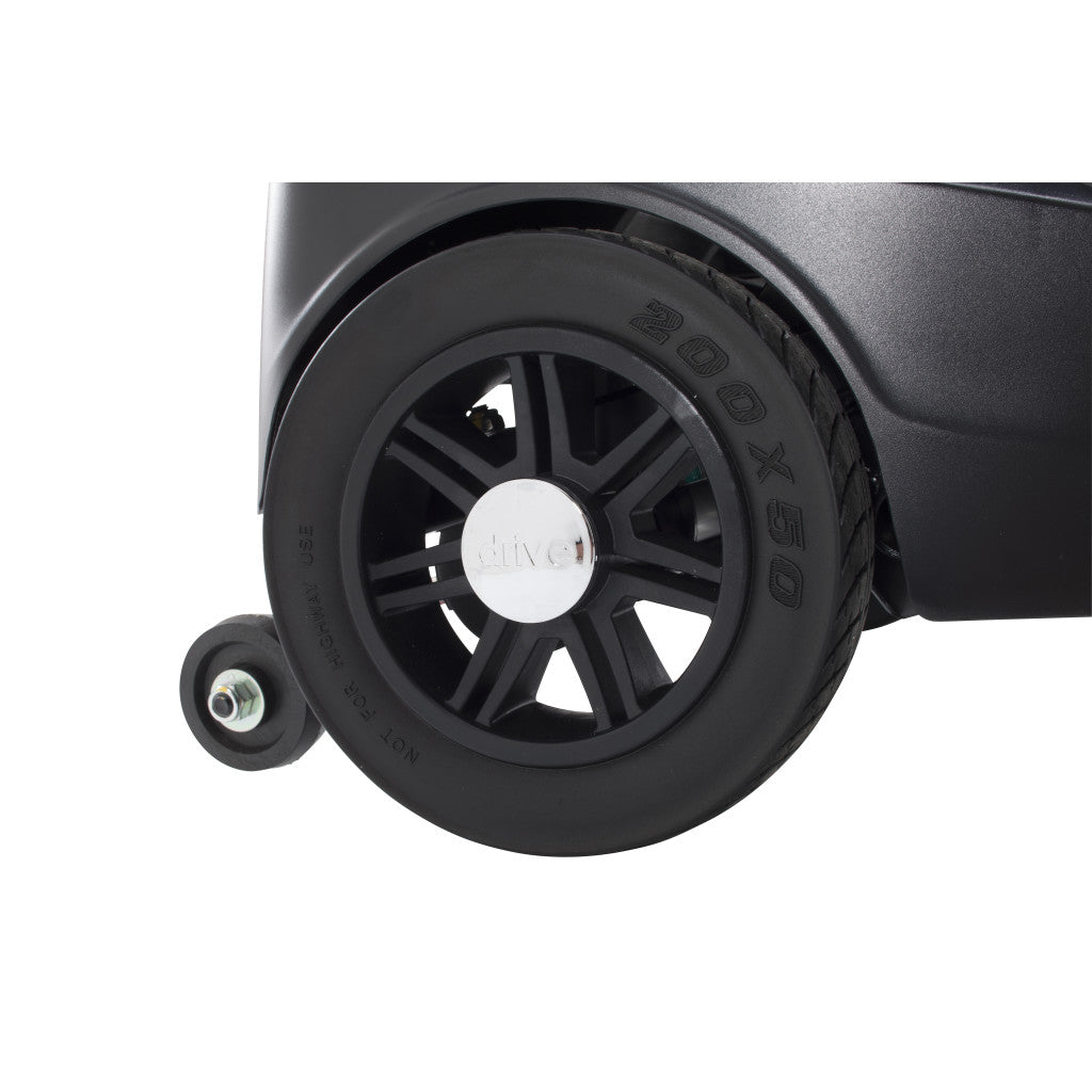 Power scooter rear wheel close-up showing black spoked hub and flat-free tire on dark body panel