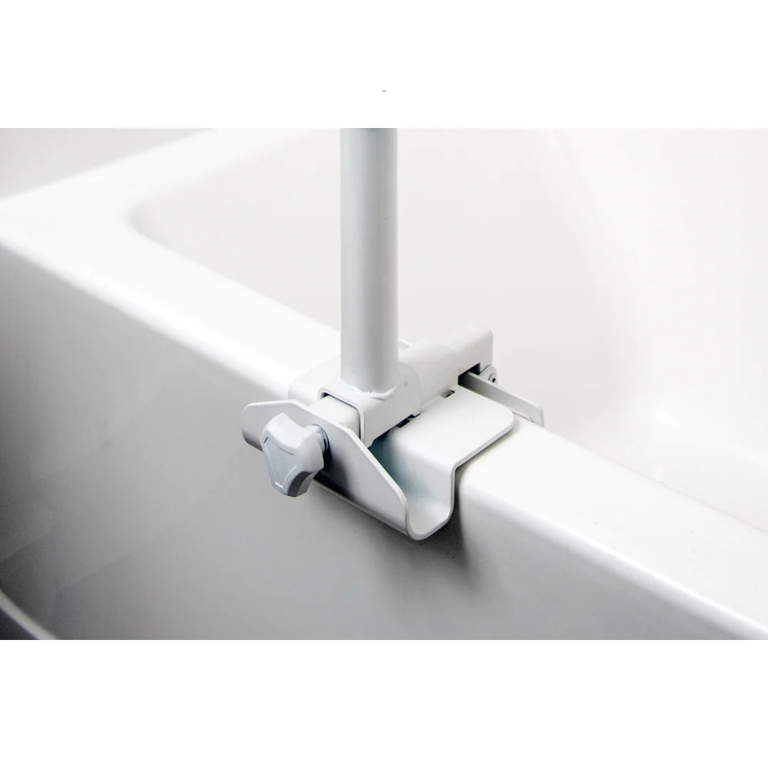 Bathtub safety rail clamp bracket with tightening knob securing a white vertical pole to the tub edge