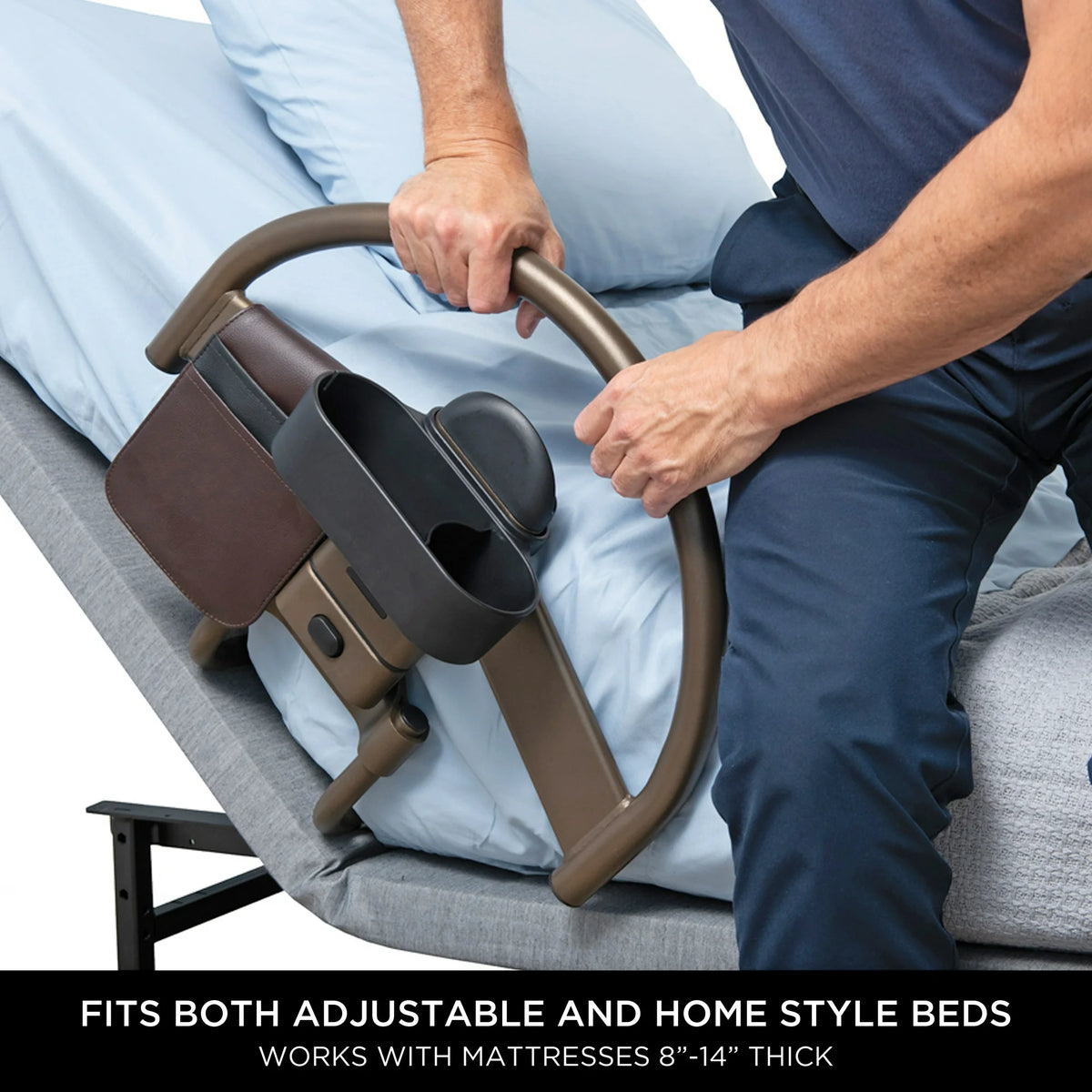 Bed safety rail with cup holder and organizer pouch, shown being gripped by a seated person on a light blue mattress