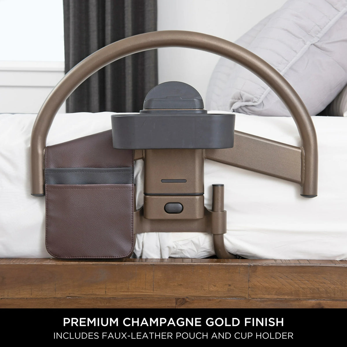 Bed safety rail in champagne gold finish with arched handle, faux-leather storage pouch, and cup holder, shown on a bed