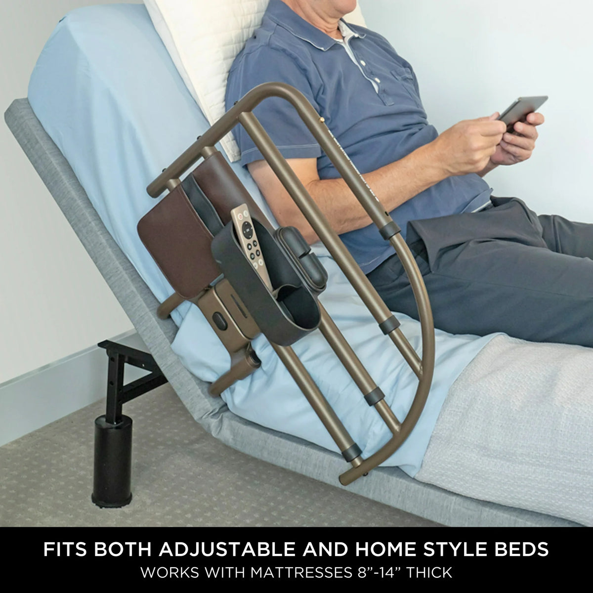 Bed rail with attached organizer pouch beside a man sitting up in bed, shown installed on an adjustable bed frame