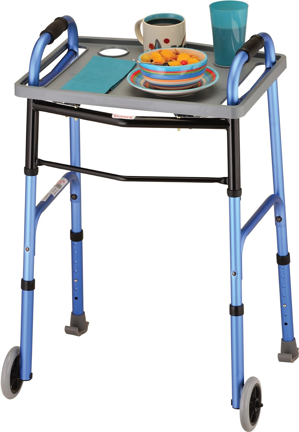 Universal walker tray in gray attached to a blue folding walker with wheels, holding a bowl, plate, mug, cup, and napkin