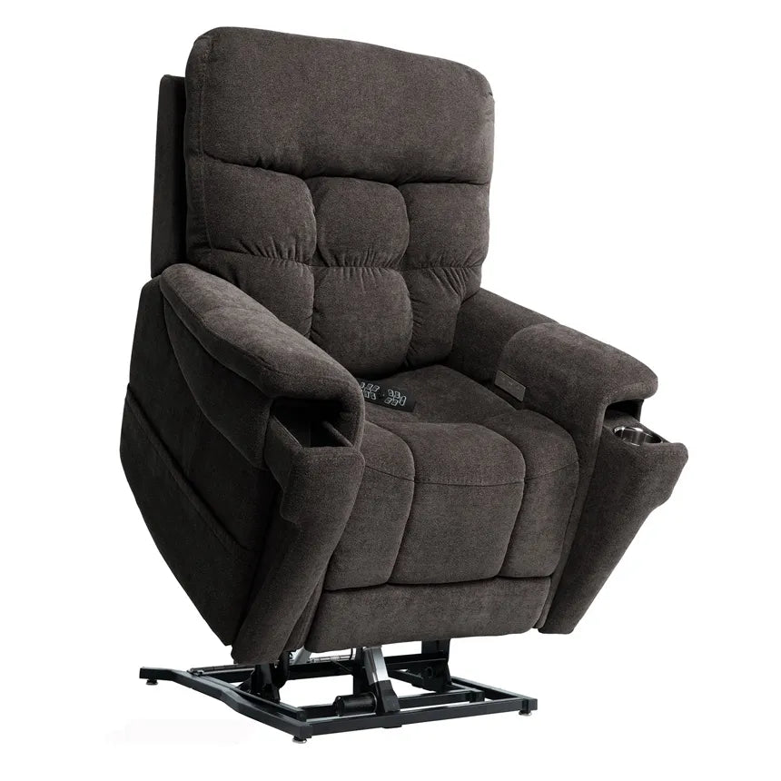 Power lift recliner in dark charcoal tufted fabric with armrest cup holders, side control panel, and visible lift mechanism