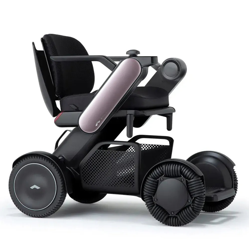 Power wheelchair with black mesh seat, joystick controller, storage basket, and four ribbed black wheels on white background