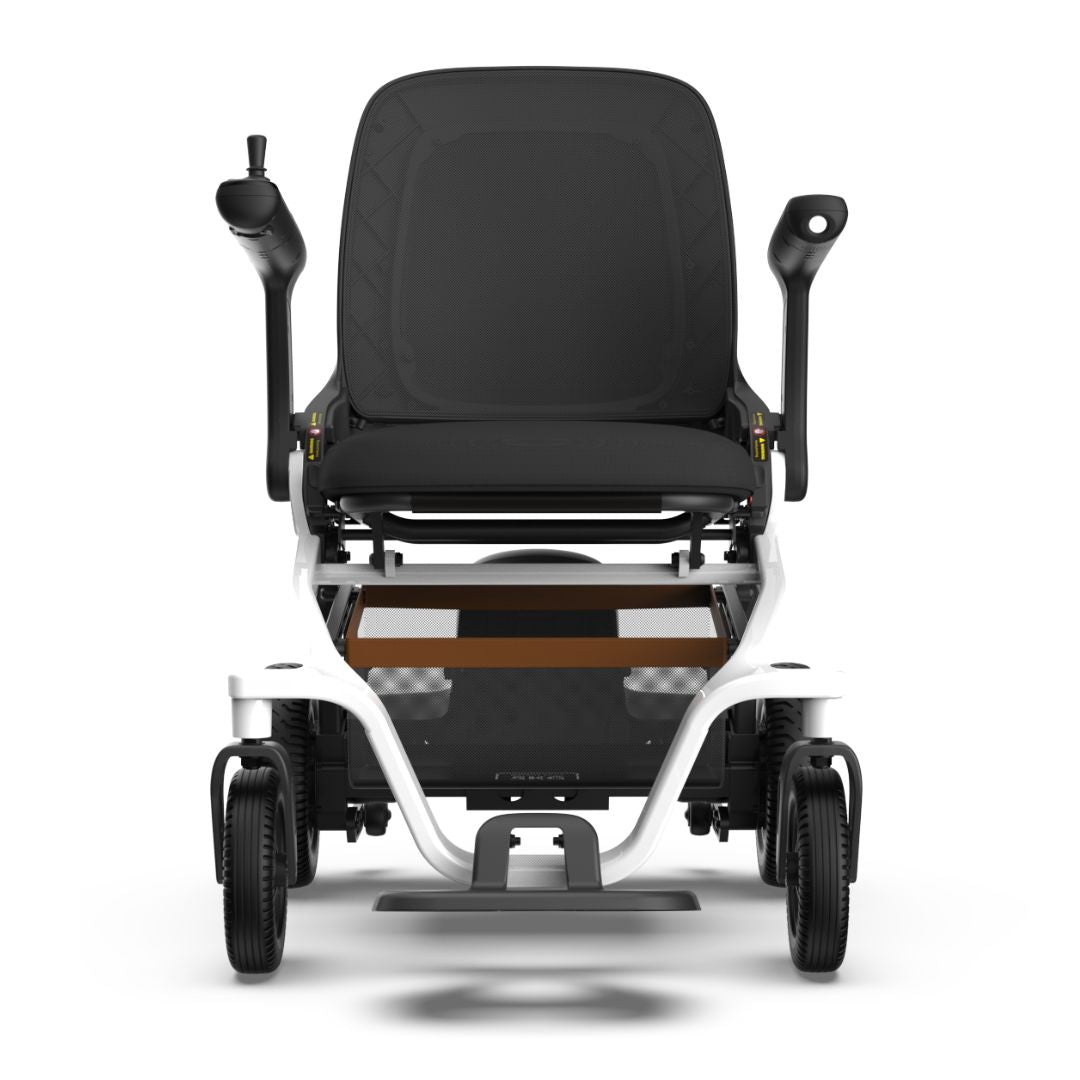 Power wheelchair with white frame, black padded seat and back, joystick controller, armrests, and four black wheels, front