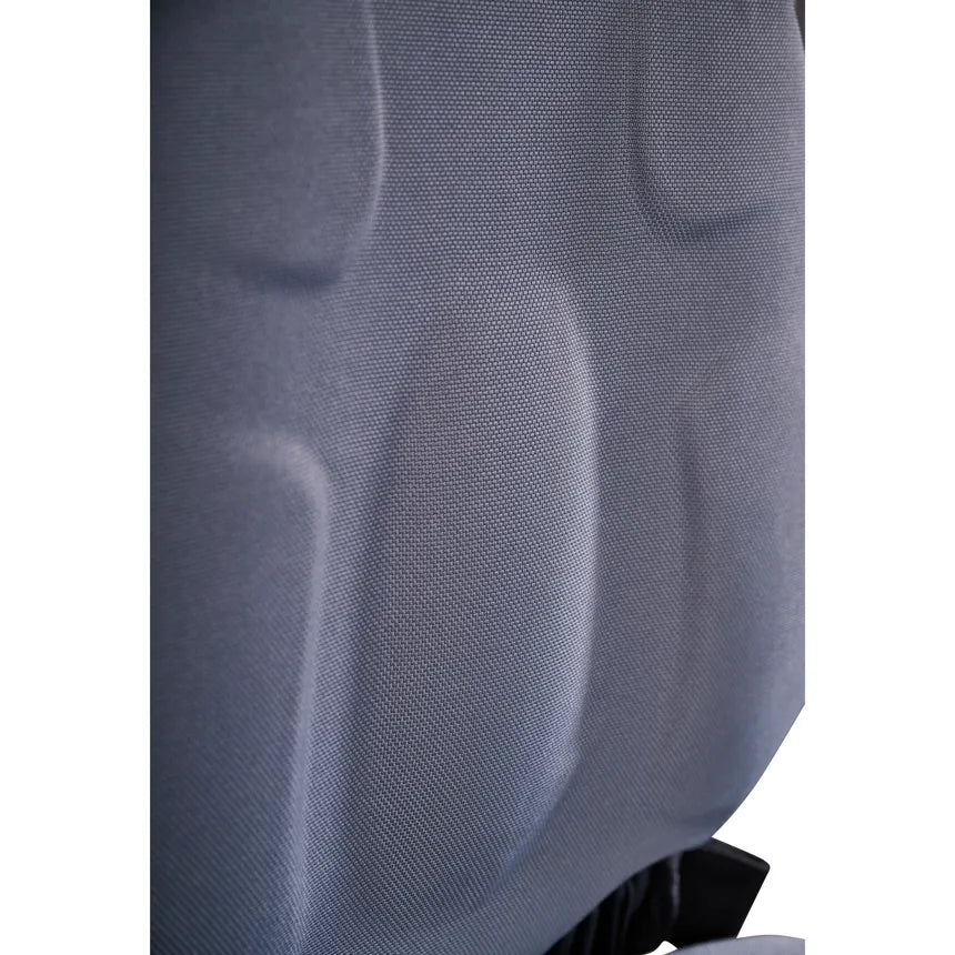 Power wheelchair backrest close-up showing contoured gray fabric upholstery with lumbar support shaping and black hardware