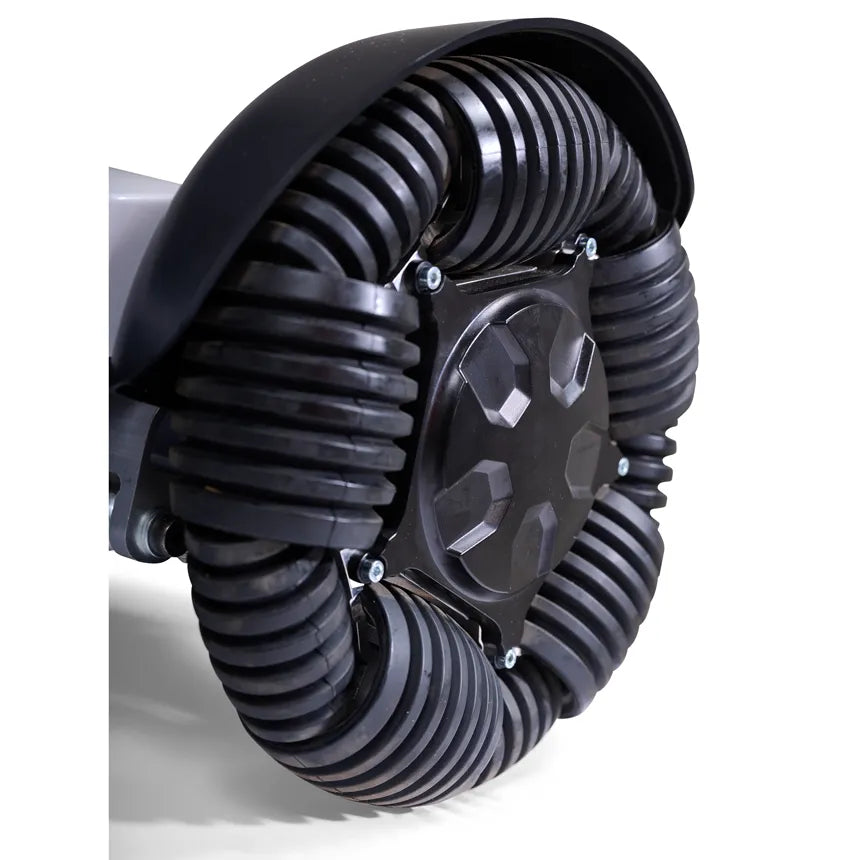 Power wheelchair rear wheel with black ribbed all-terrain tire, hub cover, and fender, shown in close-up detail