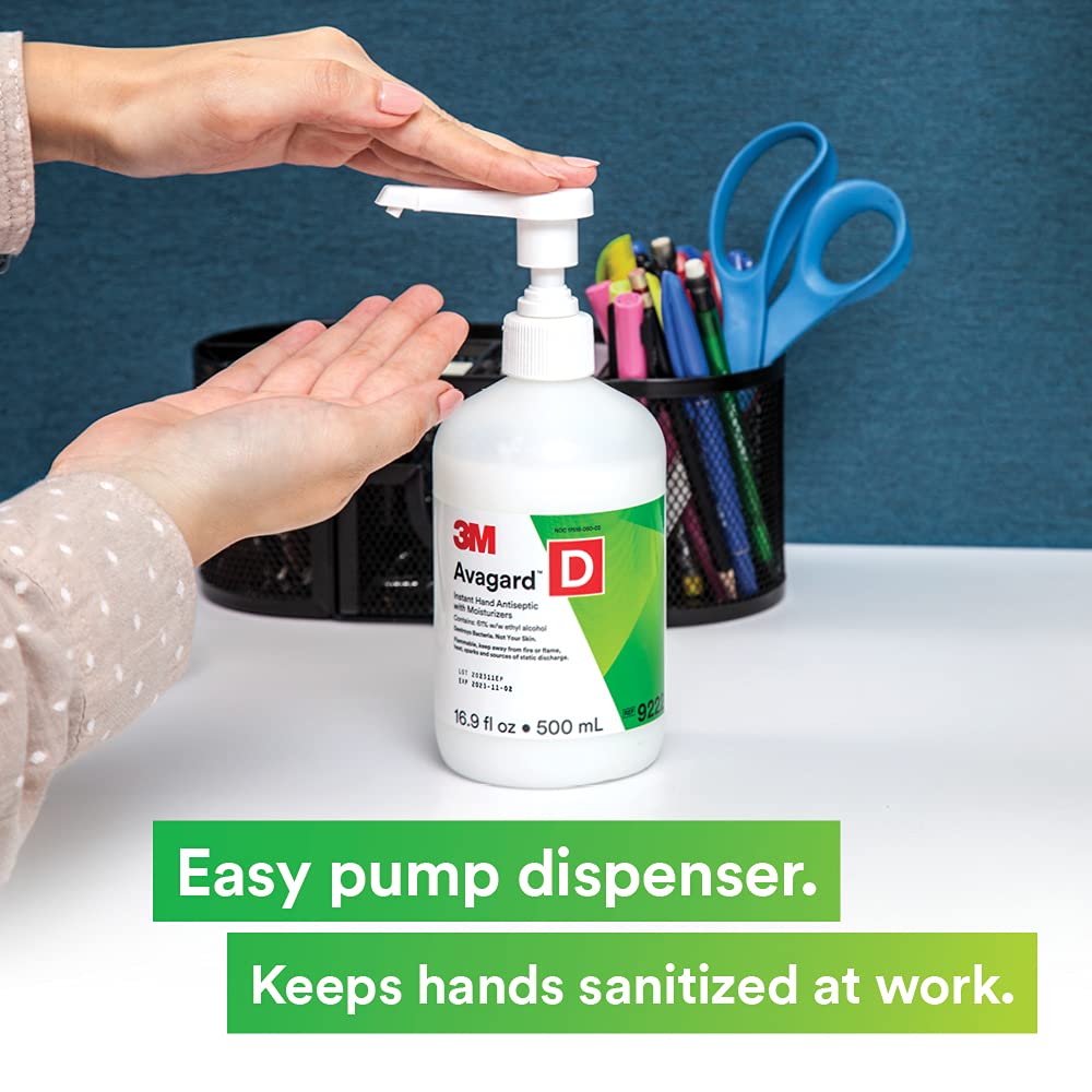 Hand antiseptic pump bottle being dispensed onto open palm on a desk, 500mL white bottle with green label