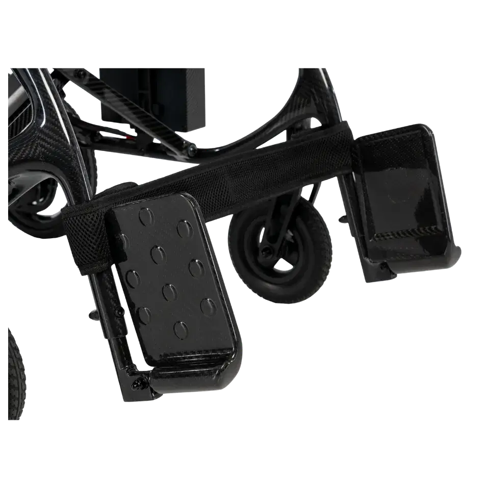 Wheelchair footrests and front caster wheels shown in close-up detail on a black carbon fiber power chair frame