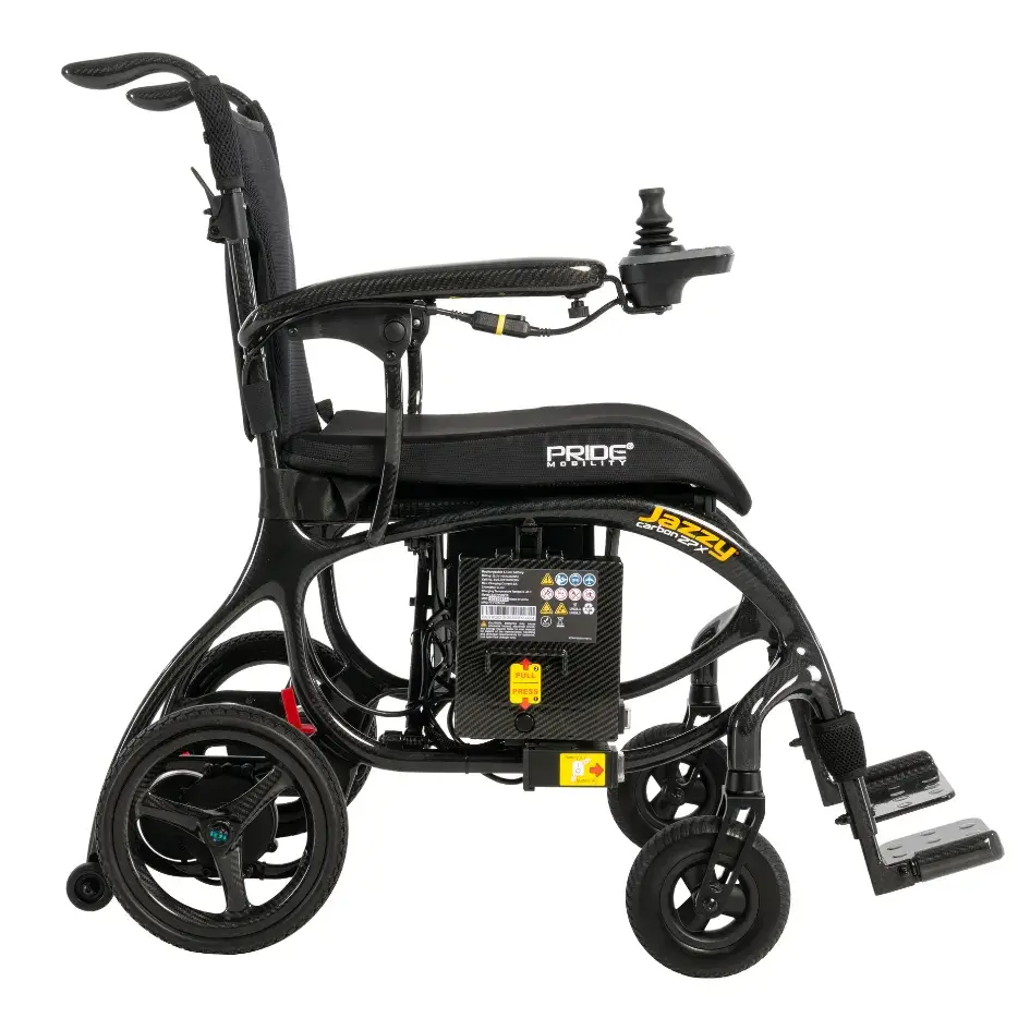 Power wheelchair with black carbon fiber frame, joystick controller, footrests, and battery pack, shown from the side