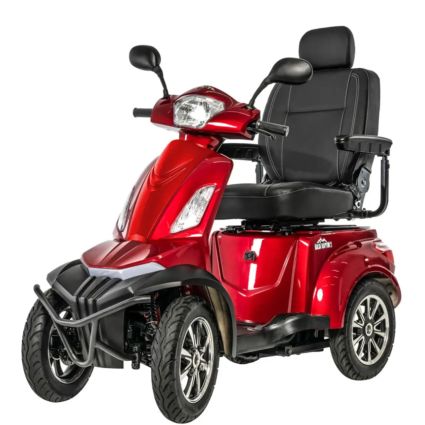 Four-wheel mobility scooter in red with black padded captain's seat, headlight, front bumper guard, and large all-terrain