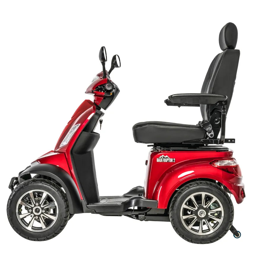Four-wheel mobility scooter in red with black high-back captain's seat, armrests, large all-terrain tires, and side mirror