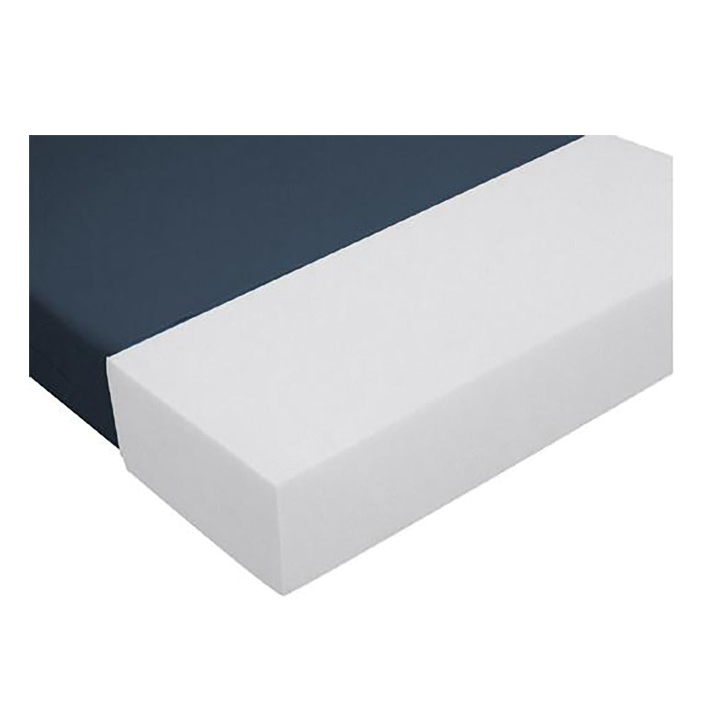 Bariatric foam mattress with navy blue cover on top and exposed white foam corner visible on white background