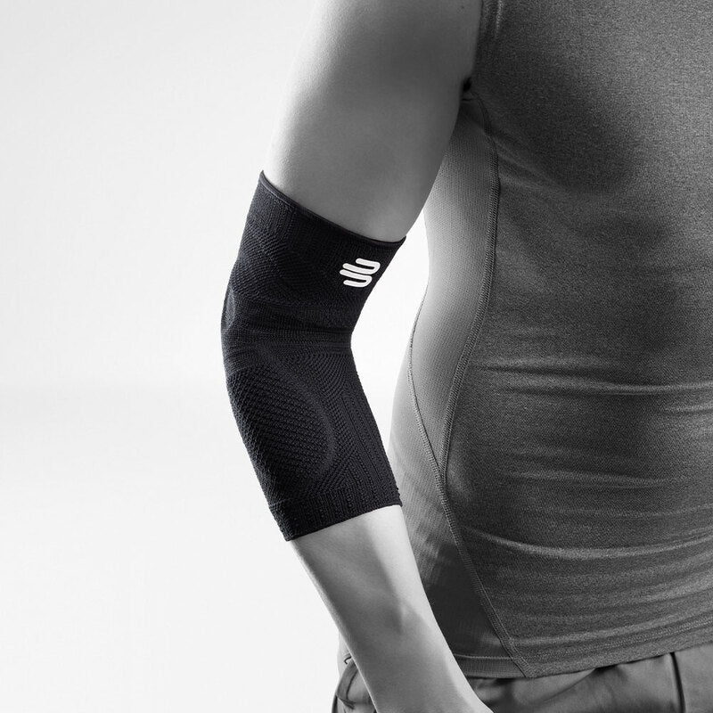 Bauerfeind Sports Elbow Support compression sleeve in black worn on a person's elbow, shown in black and white photo