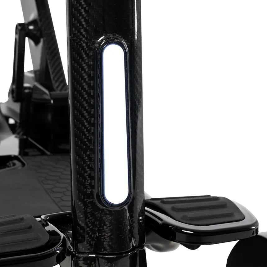 Power scooter tiller column in carbon fiber finish with built-in LED light strip and black footrests visible