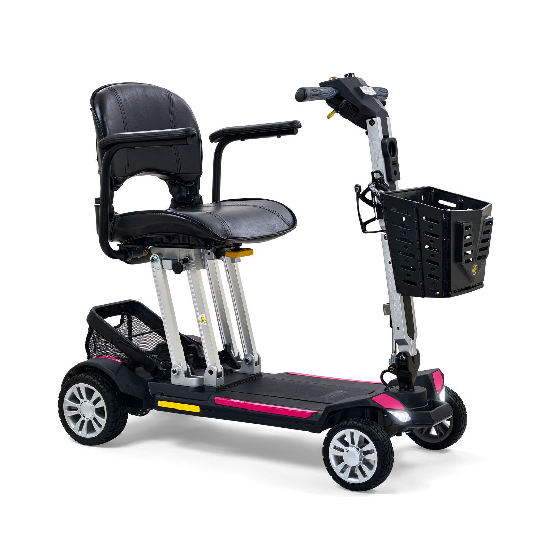 Four-wheel folding mobility scooter in black and pink with padded seat, tiller controls, front basket, and rear storage bag